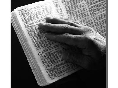 hand on open Bible