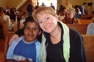 woman with arm around boy