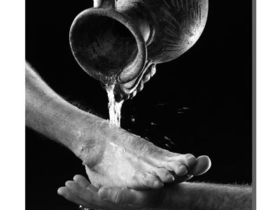 water pouring from jar over bare foot