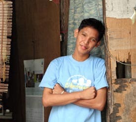 boy with arms crossed in doorway