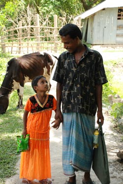 man and girl holding hands in front of cow