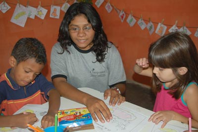 two girls and a boy coloring