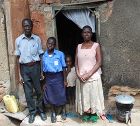 two adults and a child standing in doorway