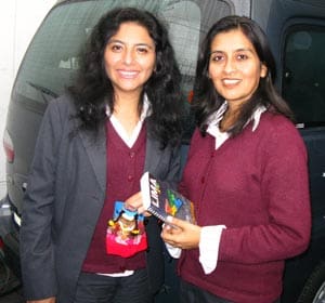 two women with Peru staff