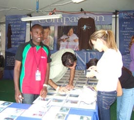 men and women at a Compassion table