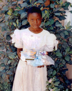 young girl holding gift items