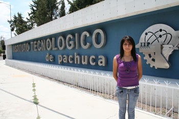 A girl standing in front of a building