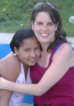 A woman hugs her sponsored child