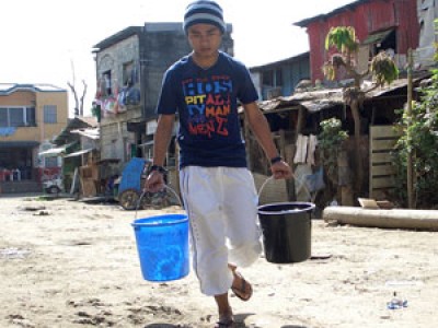 young man carrying two buckets
