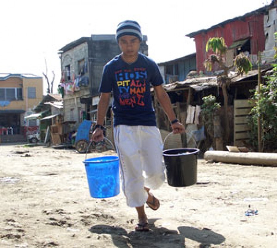 young man carrying two buckets