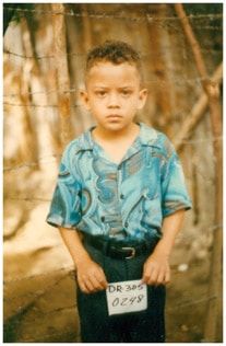 young boy holding sponsor number