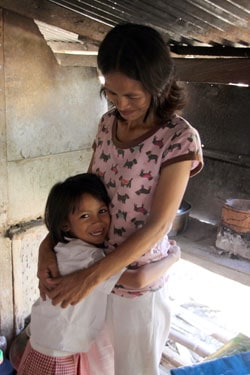 Young girl hugging a lady.