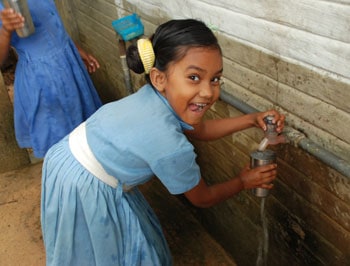 smiling girl washing her hands