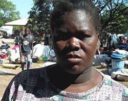 Haitian woman standing outside.