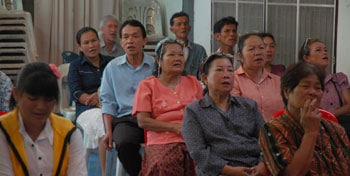 group of adults sitting and listening