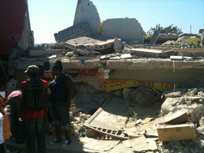people standing near debris from earthquake