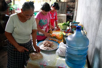 three women preparing a meal