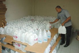 a man stacking water jugs