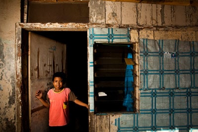 boy standing in doorway of building