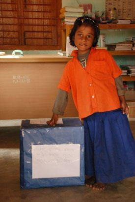 girl in orange blouse and blue skirt