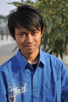 smiling young man in blue shirt