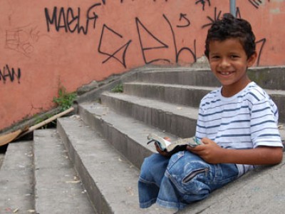 young boy sitting on steps