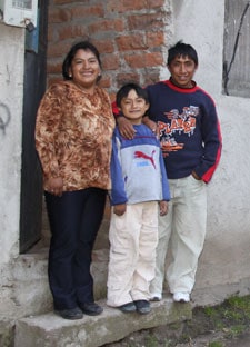 woman, man and boy standing in doorway