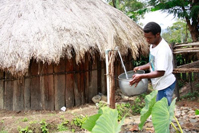 man filling container with water