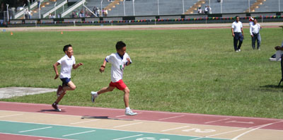 two boys racing on running track