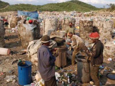 People sorting through trash at a dump