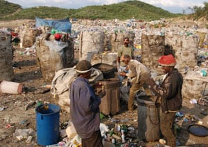 people scavenging at a dump site