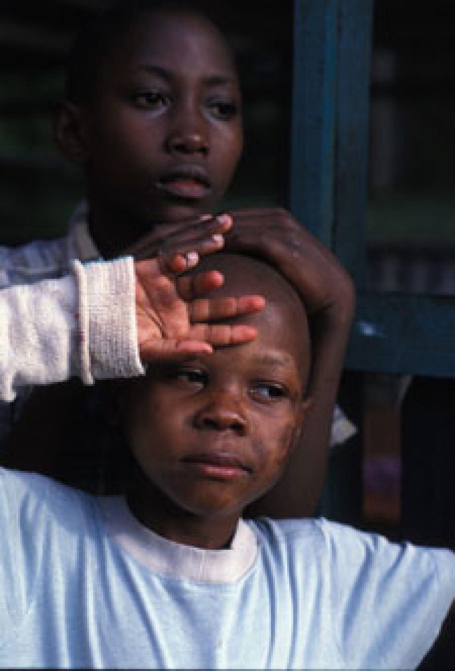 child holding hand on forehead