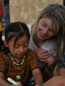 woman watching young girl write