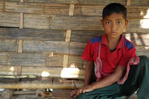 boy in a red shirt sitting on mat