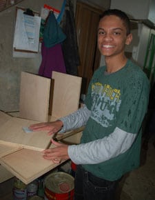 young man sanding plywood