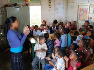 woman with group of children in classroom