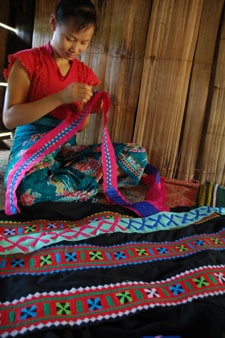 woman sitting and doing embroidery