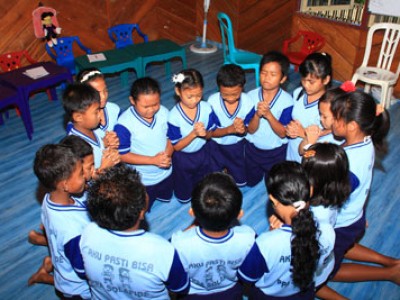 group of kneeling children praying