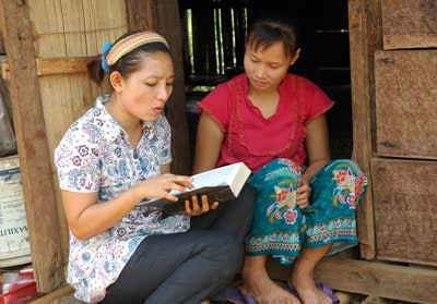 two women sitting and reading a bible