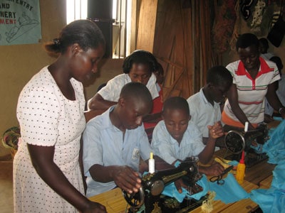 group of children learning to sew