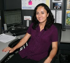 Lady sitting at a desk with a computer.