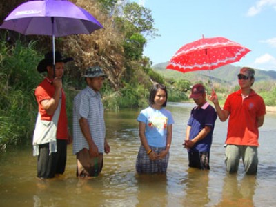 people standing in river to be baptized