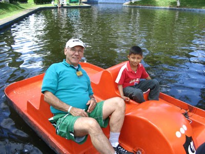 Man and boy in an orange paddle boat
