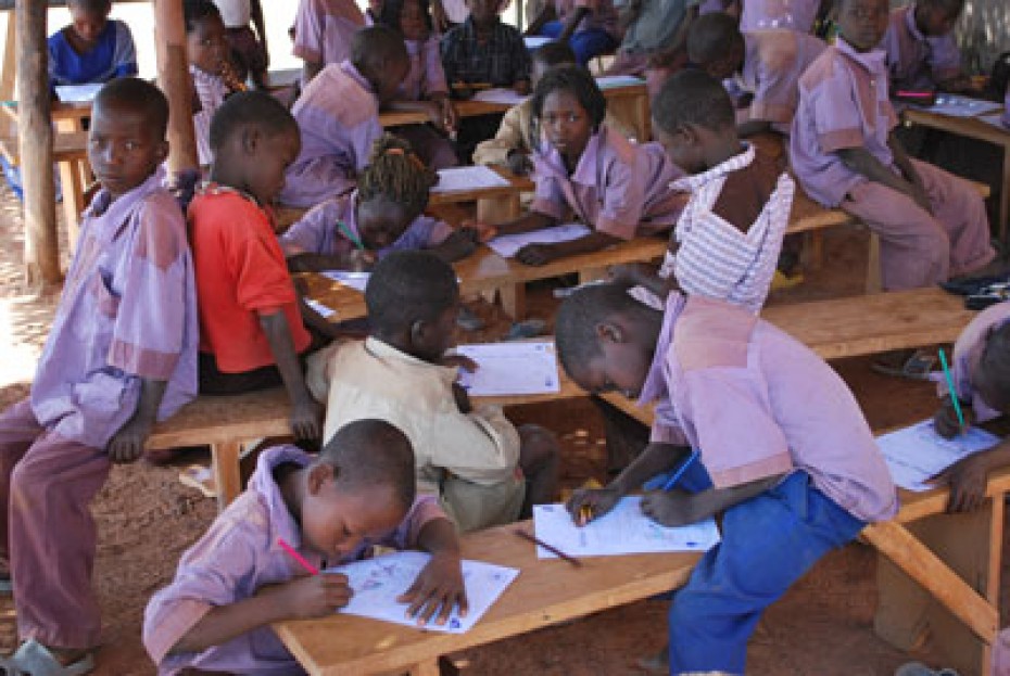 children on benches writing