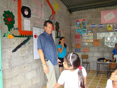 man standing in Honduran classroom