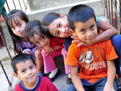 group of smiling children sitting on steps