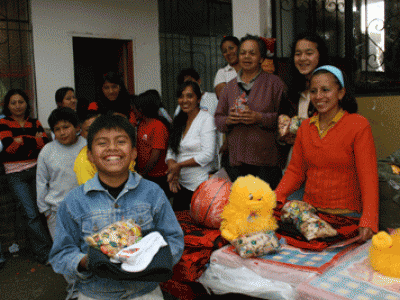 group of adults and children holding gifts