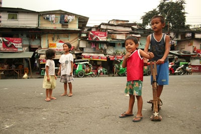 children playing in a street in front of houses