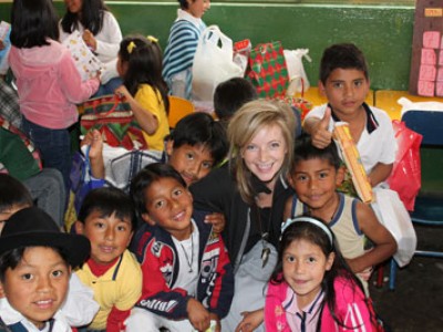 Woman in the middle of a group of children