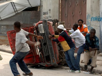 group of young man next to an overturned vehicle